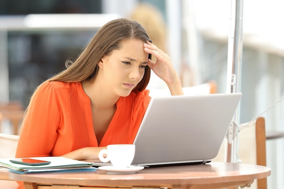 Woman looking confused while reading online information