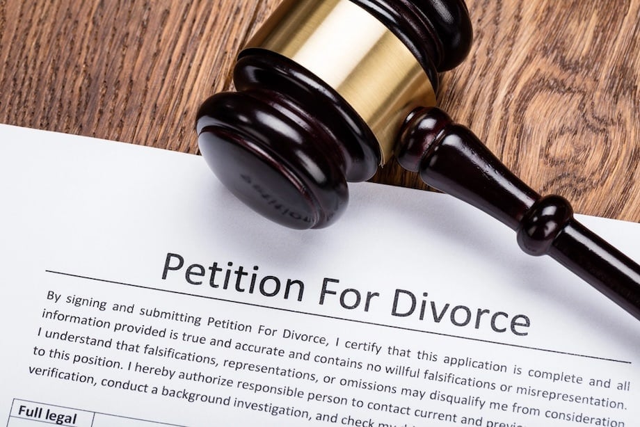 Wooden gavel on petition for divorce paper